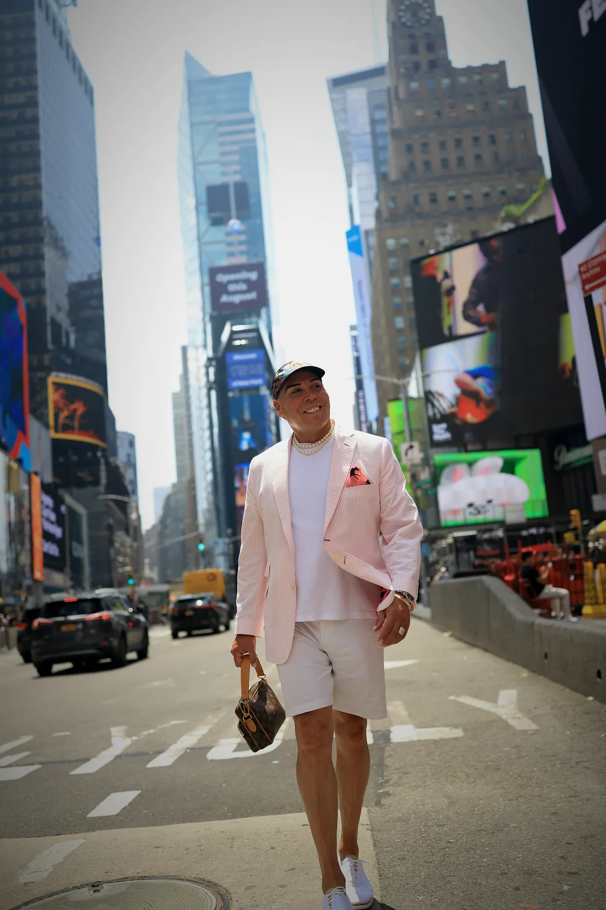 Dr. Rick Perea walking through Times Square in New York City